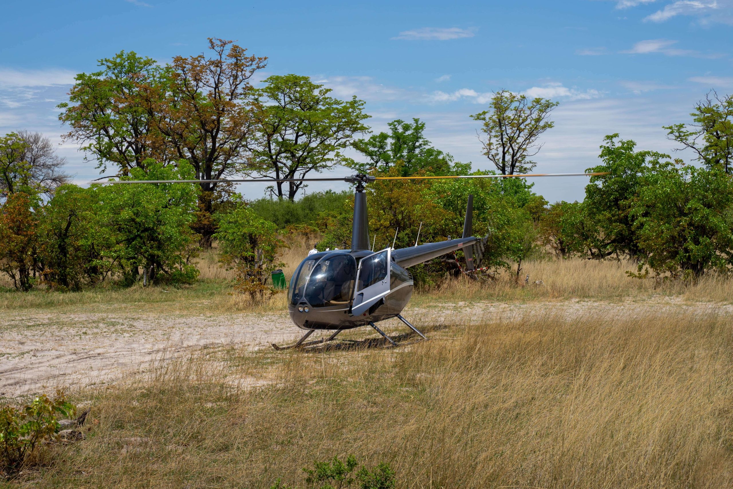 A helicopter ready for departure for a flying safari or a scenic flight over the savannah of the Okavango Delta in Botswana